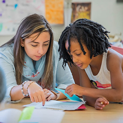 Image of teacher working with student